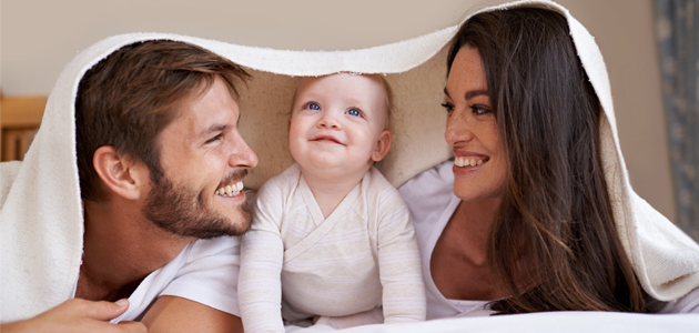 Family under bed sheet
