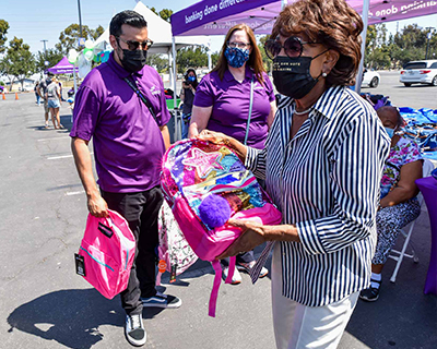 Maxine-Waters-Passing-Out-Backpacks-(2).jpg