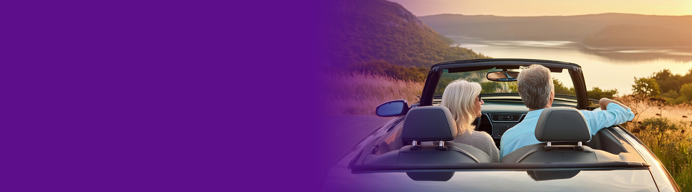 couple in a convertible over looking a lake